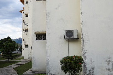 Air condition compressor mounted on an apartment wall 