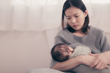 Wall Mural - Tired Mother Suffering from experiencing postnatal depression.Health care single mom motherhood stressful.