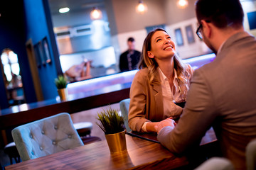 Wall Mural - Young couple enjoying lunch in the restaurant