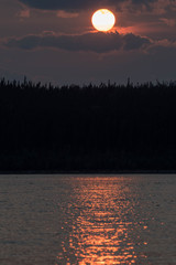 Wall Mural - close up of the sun at dusk. sun with clouds at sunset