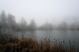 Fototapeta Tęcza - Mysterious fog over the lake 