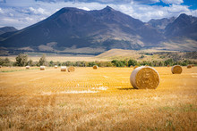 Hay Bale On A Field In Wyoming With Mountains In The Background
