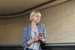 © Manuel Ruiz/ADDICTIVE STOCK - Smiling businesswoman with smartphone