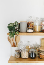 Various Cereals And Seeds In Glass Jars On The Shelves In The Kitchen. Kitchen Interior Ideas. Eco Friendly Kitchen, Zero Waste Home Concept