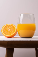 orange juice in glass whit frut and tablet