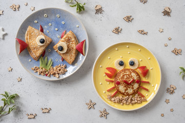 Wall Mural - Fun Food for kids. Cute crab and lobster croissants with fruit for kids breakfast