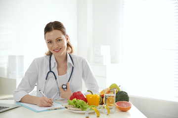 Poster - Nutritionist working at desk in office. Space for text