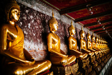 Close Up Of A Roww Of Golden Buddha Statues Along A Wall.,Wat Suthat