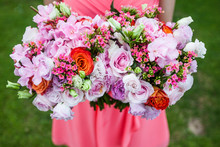 High Angle Close Up Of Woman Holding Two Bouquets Of Flowers With Pink Roses.