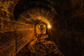 Wall Mural - Dark and creepy old historical vaulted flooded underground drainage tunnel