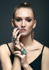 Wall Mural - Young woman with many bijouterie rings with stones on fingers