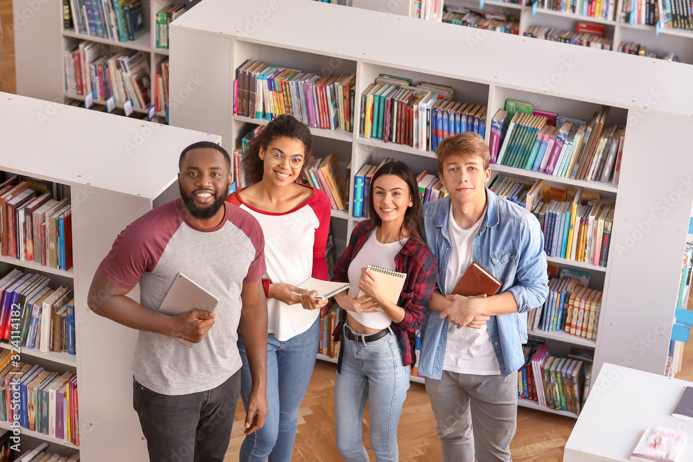 Group of young students in library