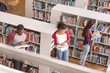 © Pixel-Shot - Young students reading books while preparing for exam in library