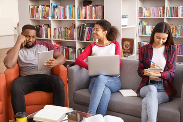 Canvas Print - Young students preparing for exam in library