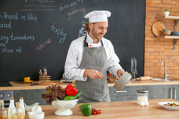 Canvas Print - Male chef cooking in kitchen