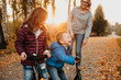 © Strelciuc - A smiling small boy is playing with his sister and mother making them to laugh like him and enjoy their walk