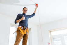 Electrician Installing Fire Alarm System Indoors