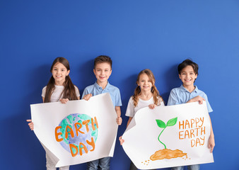 Wall Mural - Little children with drawings on color background. Earth Day celebration