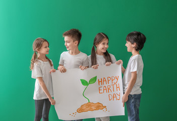 Wall Mural - Little children with drawing on color background. Earth Day celebration