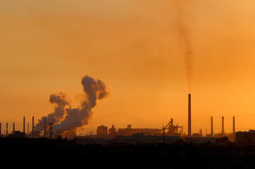 Smoke from industrial chimneys at sunset