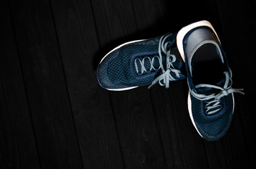 Sports shoes for sports and tourism stands on a dark background.