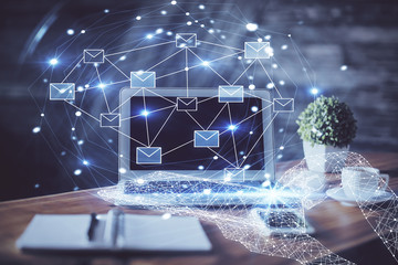 Desktop computer background in office and flying envelops hologram drawing. Multi exposure. Electronic mail concept.