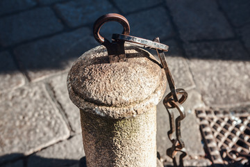 decorative pillar and chains on the street 