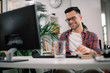 © JustLife - Businessman on video call. Handsome man in office with headphones.