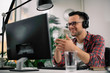 © JustLife - Businessman on video call. Handsome man in office with headphones.