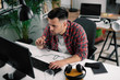 © JustLife - Man in office. Businessman working in office on his computer.