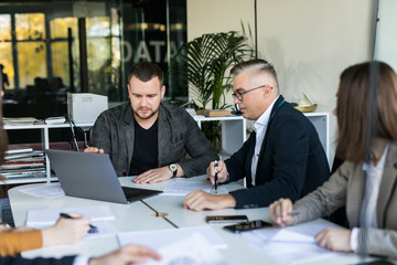 Wall Mural - Group of business partners discussing ideas and planning work in office. Team work