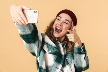 Sticker - Photo of woman taking selfie on cellphone and pointing finger at camera