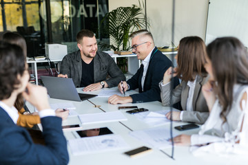 Wall Mural - Group of business partners discussing ideas and planning work in office. Team work