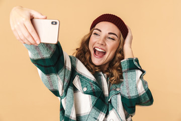 Sticker - Photo of cheerful woman taking selfie on cellphone and laughing