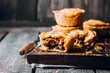 © Anikonaann - Fresh Traditional Australian meat mini pie on the wooden board on table background, closeup with copy space, rustic style