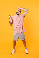 Sticker - Image of tired athletic young man in t-shirt holding water bottle