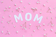 Flowers and word MOM on a light pink background