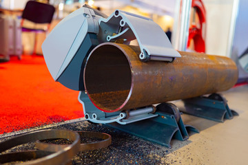 Poster - Metalworking. Equipment of Metalworking production. Device for sawing metal pipes. A special clamp ensures immobility of the pipe. Works on replacement of the pipeline.