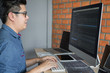 © Freedomz - Young Professional programmer working at developing programming and website working in a software develop company office, writing codes and typing data code, Programming with HTML, PHP and javascript