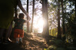 © dissx - Mother walking playing baby child boy in forest wood - Young mom in green dress and her baby in a green park having fun - Happy smiling people