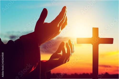 Human male hand on cross background