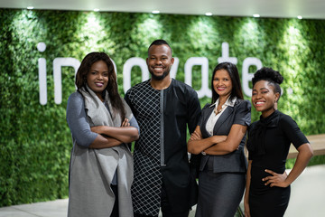 Wall Mural - Smiling group of African businesspeople standing in a modern office