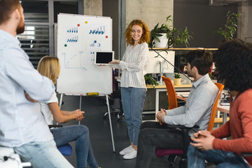 Aufkleber - Young woman with digital tablet making presentation for colleagues