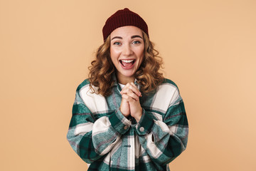 Wall Mural - Photo of nice excited woman in knit hat smiling and looking at camera