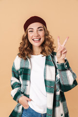 Poster - Photo of pretty joyful woman laughing and gesturing peace sign