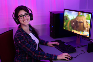 Wall Mural - Gamer Girl At PC Smiling To Camera Sitting At Home