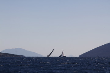 Sailing ship yachts with white sails in race the regatta in the open sea