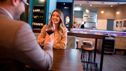 Wall Mural - Young couple enjoying lunch in the restaurant