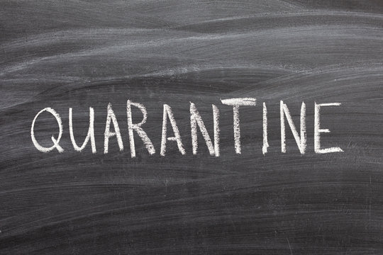 The teacher left a message for the students with chalk on the blackboard. School quarantine concept