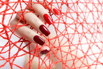 Fashionable red nail Polish color from light to dark on a rectangular shape.Nail art.